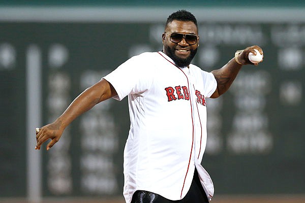 Former Red Sox player David Ortiz throws out a ceremonial first pitch before Monday night's game against the Yankees in Boston.