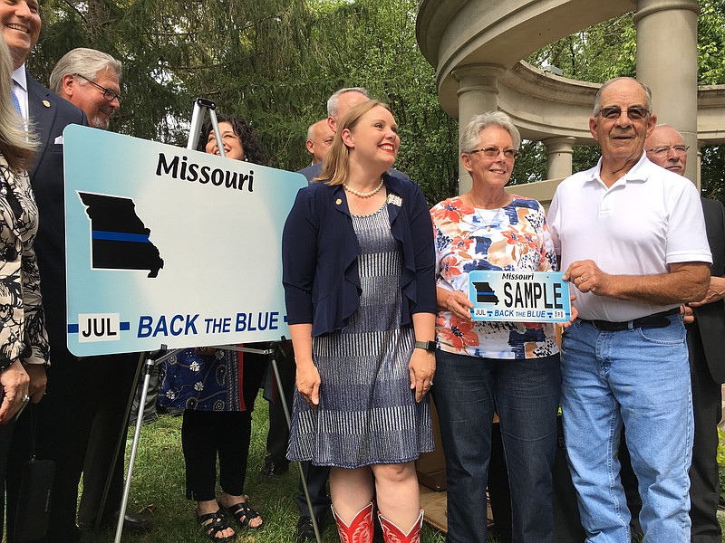 State Rep. Sara Walsh, R-Ashland, left, stands alongside Beverly and David Thomas, parents of Molly Thomas-Bowden, a Columbia police officer who was killed in the line of duty in 2005, during a ceremony Tuesday, Sept. 10, 2019, at the Missouri State Capitol unveiling Missouri's new "Back the Blue" license plate. Walsh sponsored the legislation authorizing the new specialty license plate.