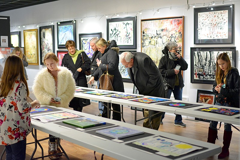 <p style="text-align:right;">News Tribune file</p><p><strong>Children and their families look at youth art contest entries in February during an open house at the Jefferson City Museum of Modern Art. The museum announced last week that it will begin additional open hours of 2-4 p.m. Sundays for walk-ins.</strong></p>