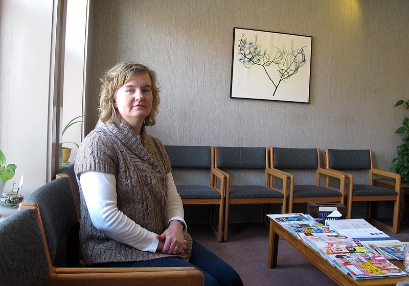 FILE - In this Feb. 20, 2013, file photo, Tammi Kromenaker, director of the Red River Valley Women's Clinic, North Dakota's sole abortion provider, sits in the waiting area of the facility in Fargo, N.D. A federal judge in North Dakota on Tuesday, Sept. 10, 2019, has blocked a state law passed earlier this year that required physicians to tell women they may reverse a so-called medication abortion if they have second thoughts. Kromenaker, said the law would force doctors to give false information that is not backed up by science. (AP Photo/Dave Kolpack, File)
