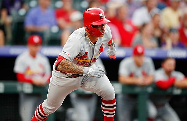 Kolten Wong of the Cardinals breaks out of the box on a grounder during Tuesday night's game against the Rockies in Denver.