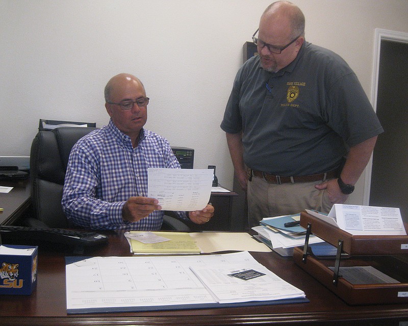 Wake Village's new Police Chief Steve Shelley, left, studies some police report files with Wake Village Criminal Investigator Todd Aultman. 