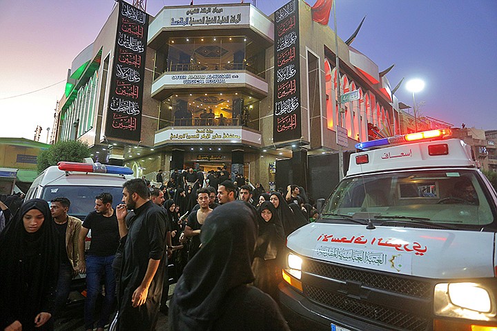 People gather outside a hospital while ambulances bring injured people after a walkway collapsed and set off a stampede as thousands of Shiite Muslims marked one of the most solemn holy days of the year in the holy city of Karbala, Iraq, Tuesday, Sept. 10, 2019. Officials say at least 31 people have died and around 100 others were injured in the chaos Tuesday, which occurred toward the end of the Ashoura procession, causing panic and a stampede, according to two officials. (AP Photo/Anmar Khalil)