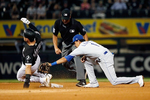 Yolmer Sanchez of the White Sox beats the tag of Nicky Lopez of the Royals at second base as umpire Jeramie Rehak watches during the fourth inning of Tuesday night's game in Chicago.