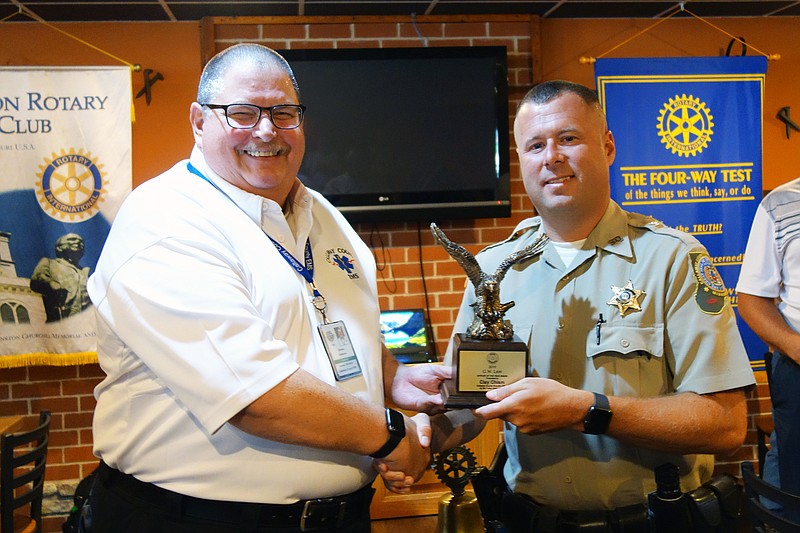 <p>Helen Wilbers/For the News Tribune</p><p>Charles Anderson, director of the Callaway County Ambulance District, presents Callaway County Sheriff Clay Chism with the 2019 G. W. Law Award. The award recognizes a local law enforcement officer who embodies the Rotary Club ideal “service over self.”</p>