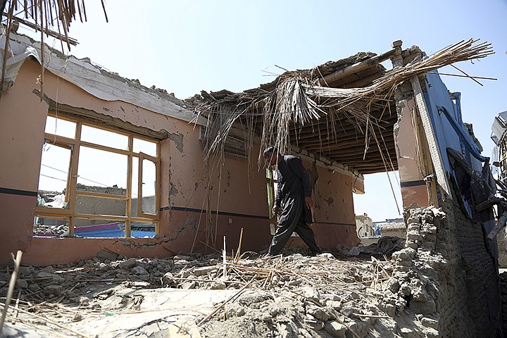 In this Tuesday, Sept. 10, 2019, photo, Samiullah inspects the remains of his damaged house after a large explosion last week near a compound housing several foreign organizations and guesthouses, in Kabul, Afghanistan. President Donald Trump says U.S.-Taliban talks on ending the war in Afghanistan are "dead," deeply unfortunate wording for the Afghan civilians who have been killed by the tens of thousands over almost 18 years. (AP Photo/Rahmat Gul)