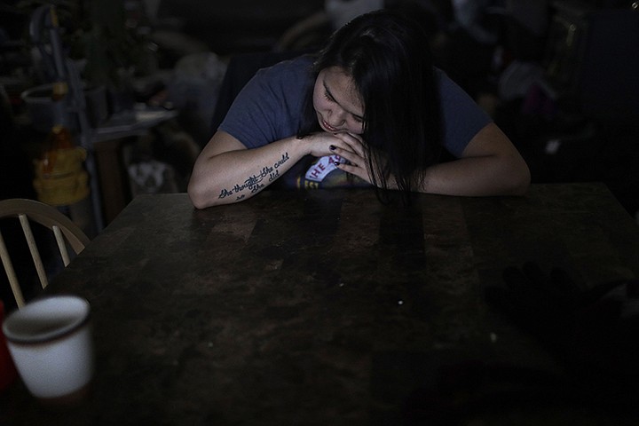 In this Feb. 16, 2019, photo, Deidre Levi rests her head for a moment in her grandmother's house before a basketball game in the Native Village of St. Michael, Alaska. Levi says she spoke up about being sexually assaulted because she wanted to be a role model for girls in Alaska. (AP Photo/Wong Maye-E)