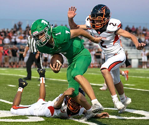 Blair Oaks quarterback Dylan Hair works his way through the Oak Grove defense during last Friday's game against Oak Grove at the Falcon Athletic Complex in Wardsville.