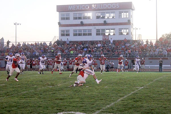 California senior Clayton Winkler drags a Mexico defender up the field during Friday's game at Mexico.