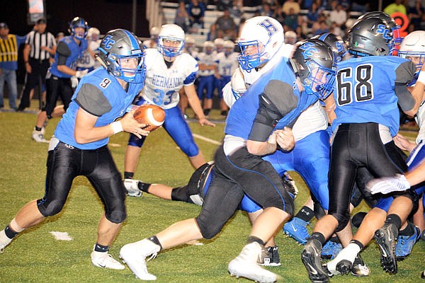 South Callaway quarterback Cole Shoemaker looks for an opening to run through at the line of scrimmage during the Bulldogs' 40-27 loss to Hermann last Friday in Mokane. South Callaway opens Eastern Missouri Conference play tonight at Montgomery County.