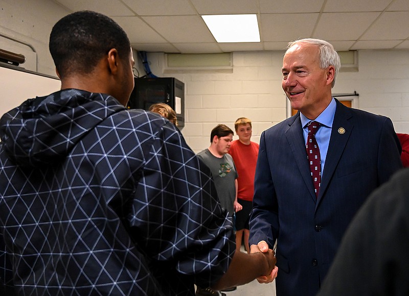 Arkansas Gov. Asa Hutchinson shakes hands with students in the computer science class at Foreman High School before giving a presentation about computer coding.