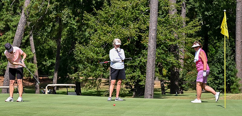 Players eye the hole as they prepare to putt during the opening round of the Twice As Nice Ladies Invitational on Wednesday at Texarkana Country Club. The 51st annual tournament concludes today with a scramble.