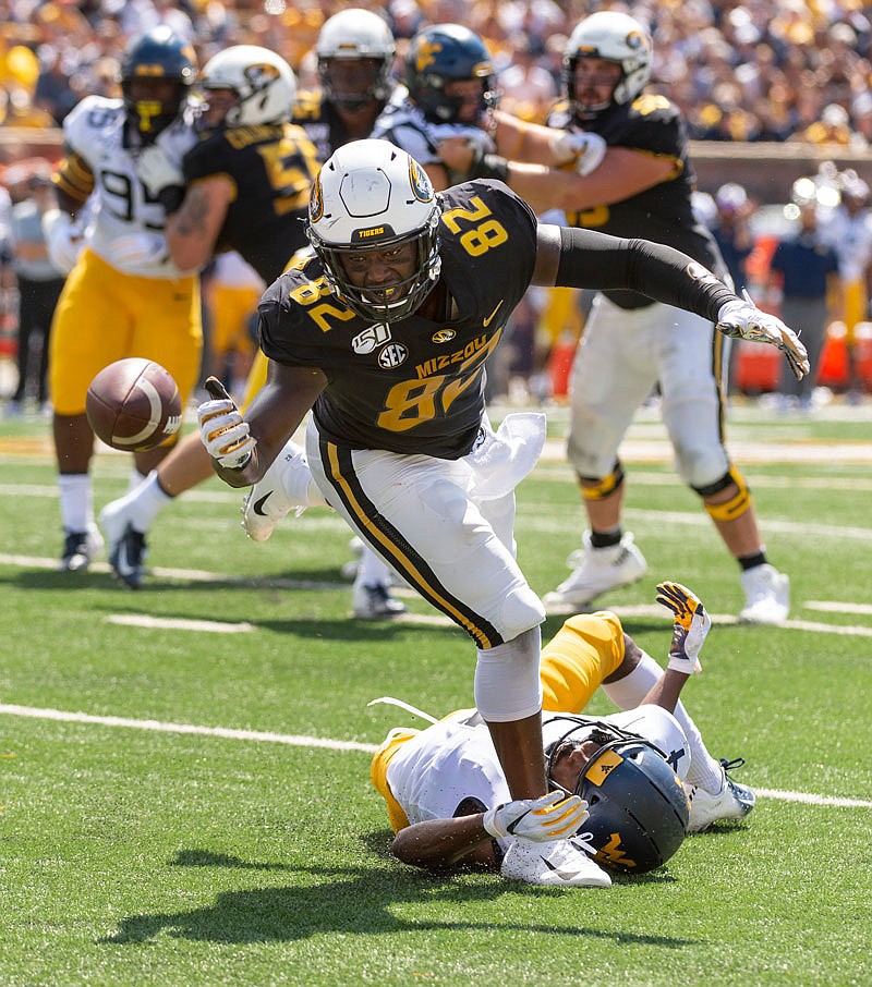 Missouri tight end Daniel Parker Jr. attempts to make a catch while being tripped by West Virginia safety Josh Norwood during last Saturday's game at Faurot Field.