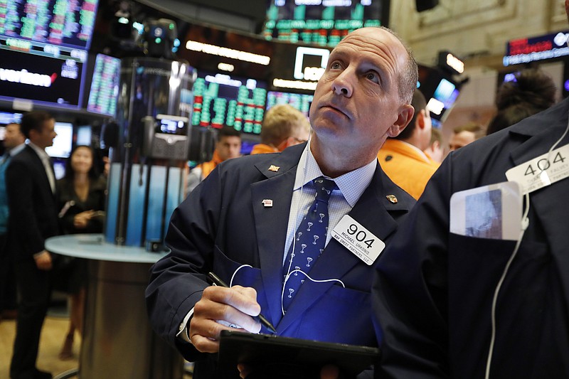 Trader Michael Urkonis works on the floor of the New York Stock Exchange, Friday, Sept. 13, 2019. Stocks are having a mixed performance early on Wall Street Friday as gains in banks and energy companies are offset somewhat by a drop in technology stocks. (AP Photo/Richard Drew)