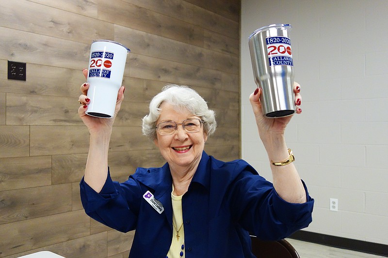 Diane Burre Ludwig, of the Kingdom of Callaway Historical Society, lifts a pair of branded mugs for Callaway 200. The yearlong celebration kicks off Nov. 15.