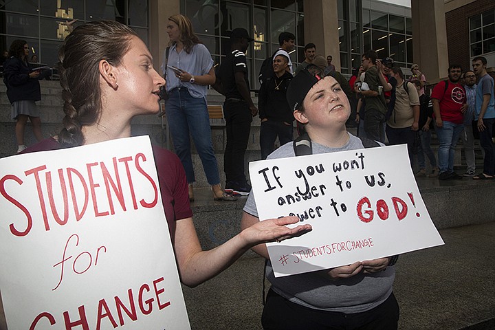 Tessa Russell ,left, a senior in psychology, and Mel Daniels, right, a senior in English, converse with students during a student protest on Friday, Sept. 13, 2019, at Liberty University in Lynchburg, Va. Students at Liberty University gathered to protest in the wake of news articles alleging that school president Jerry Falwell Jr. "presides over a culture of self-dealing" and improperly benefited from the institution. Falwell Jr. told The Associated Press on Tuesday that he wants the FBI to investigate what he called a "criminal" smear campaign orchestrated against him by several disgruntled former board members and employees. (Emily Elconin/The News & Advance via AP)