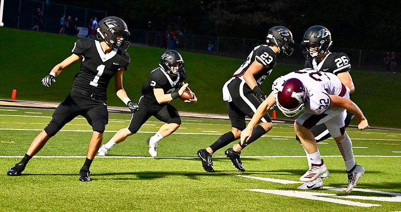 Hawks punt returner Bruce Garrett runs the ball up the field while being defended by Sergio Rodriguez (1), Dylan Hopkins (23) and Logan Johnson (26) against Atlanta Rabbits player Jagger Dyer (32) on Friday in Texarkana, Texas.