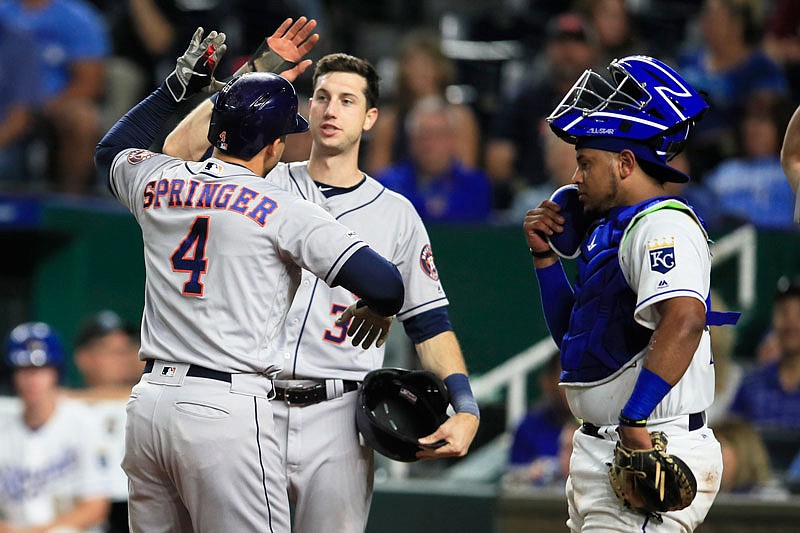 Royals catcher Meibrys Viloria watches as Houston's George Springer celebrates with teammate Kyle Tucker after Springer hit a three-run home run in the top of the ninth inning of Friday's game at Kauffman Stadium. The Astros won 4-1. Viloria hit a game-tying sacrifice fly in the bottom of the eighth inning.