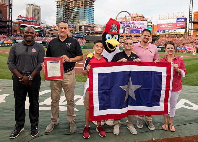 The Silver Star Families of America presented the St. Louis Cardinals with the 2019 Commendation Award for their support of veterans. Participating in the presentation were, from left, Michael Hall, vice president of communications and director of Cardinals Care; Jeremy P. Amick; Tyler Johnson; Fredbird; Shawn Johnson; Brian Schwarze, grandson of Stan Musial; and Tina Amick.