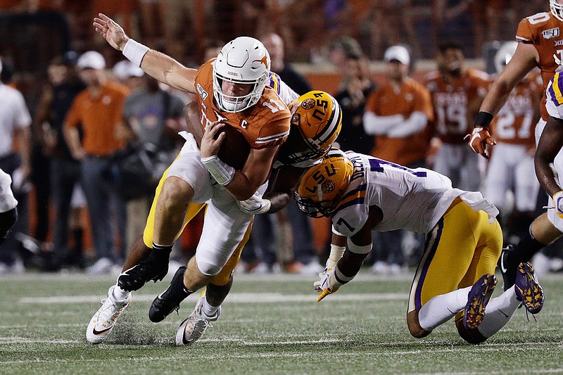 Texas quarterback Sam Ehlinger (11) is hit by LSU defensive end Justin Thomas (93) during the second half of an NCAA college football game Saturday, Sept. 7, 2019, in Austin, Texas. (AP Photo/Eric Gay)