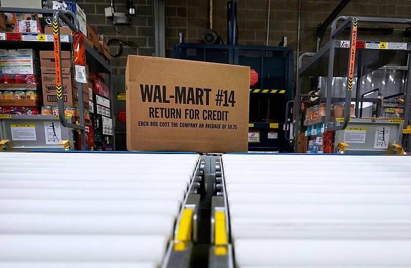 In this Nov. 9, 2018, file photo, a box of merchandise is unloaded from a truck and sent along a conveyor belt at a Walmart Supercenter in Houston. Walmart is rolling out an unlimited grocery delivery subscription service this fall for a $98 annual fee. The service will reach 1,400 stores in 200 markets and allows the nation's largest grocer to further tap into time-starved shoppers looking for convenience. (AP Photo/David J. Phillip, File)