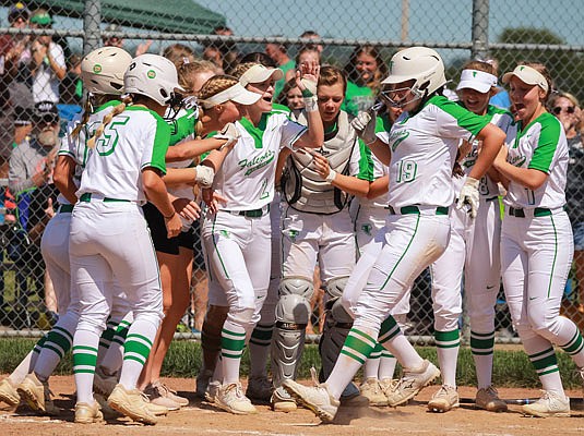 Kathleen Groner (19) is greeted by her Blair Oaks teammates as she crosses the plate after her home run during Saturday's game against Troy-Buchanan in Wardsville.