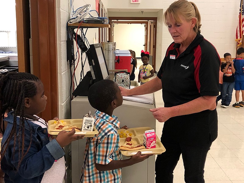 Sandra Calhoun, kitchen manager at Clinton Primary School in Hope, Ark., checks student lunch numbers during the cafeteria's daily meal service. Calhoun has been named one of 200 Ring of Stars winners worldwide for Aramark, the Hope Public Schools food services vendor.  (Submitted photo by Ken McLemore/Hope Public Schools)

