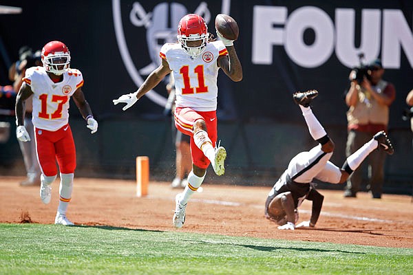 Chiefs wide receiver Demarcus Robinson (11) celebrates after scoring a touchdown as teammate Mecole Hardman (17) looks on during the first half of Sunday afternoon's game against the Raiders in Oakland, Calif. At right is Raiders cornerback Gareon Conley.