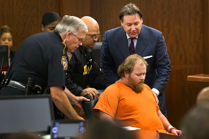 In this July 11, 2014 file photo, Ronald Lee Haskell collapses as he appears in court in Houston. A forensic psychiatrist told jurors Monday, Sept. 16, 2019, that Haskell, accused of fatally shooting six members of his ex-wife's family was not responsible for his actions because of severe mental illness that made him believe voices in his head were telling him to carry out the killings. The psychiatrist was expected to be the final witness from defense attorneys for Haskell, who is charged with capital murder in the July 2014 attack in a suburban Houston home. (Brett Coomer/Houston Chronicle via AP, Pool)