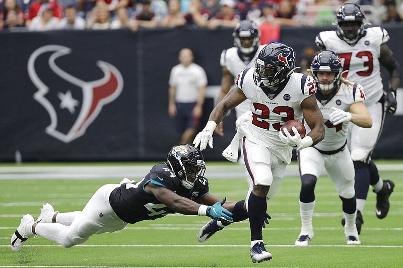 Houston Texans running back Carlos Hyde (23) runs past Jacksonville Jaguars middle linebacker Myles Jack (44) during the first half of an NFL football game Sunday, Sept. 15, 2019, in Houston. (AP Photo/David J. Phillip)