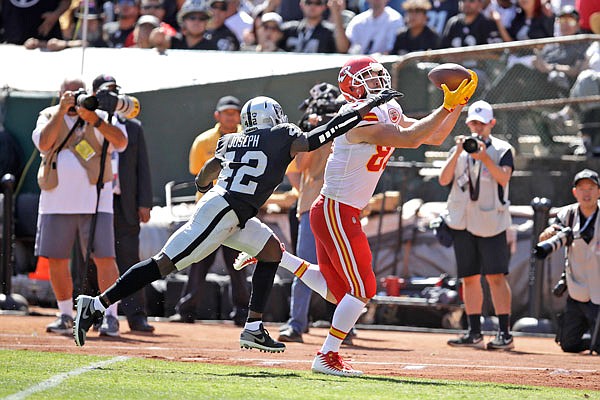 Chiefs tight end Travis Kelce scores a touchdown as Raiders free safety Karl Joseph looks on during the first half of Sunday afternoon's game in Oakland, Calif.