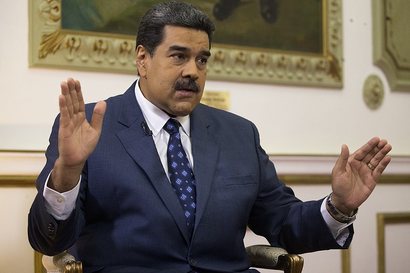 FILE - In this Feb. 14, 2019 file photo, Venezuela's President Nicolas Maduro speaks during an interview with The Associated Press at Miraflores presidential palace in Caracas, Venezuela. Maduro ordered on Tuesday, Sept. 3, 2019, Venezuela's military to hold exercises along the border with Colombia, accusing the neighboring nation's president of plotting an attack as tensions mount between the two South American countries. (AP Photo/Ariana Cubillos, File)