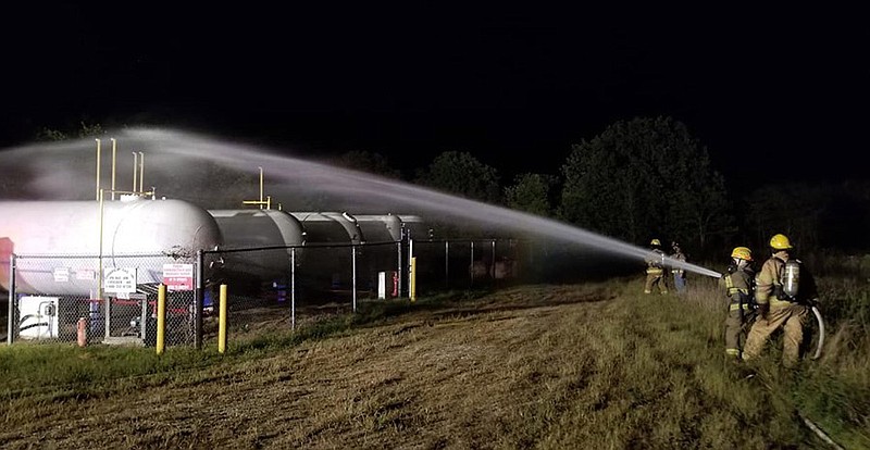 In this photo posted to their Facebook page, Iberia firefighters are shown bringing a leaking propane tank under control by spraying it with water Monday night, Sept. 16, 2019, to prevent new leaks. (Iberia Rural Fire Protection District photo)