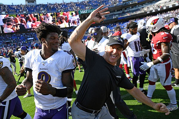 Ravens quarterback Lamar Jackson celebrates with head coach John Harbaugh after Sunday's game against the Cardinals in Baltimore. The Ravens won 23-17