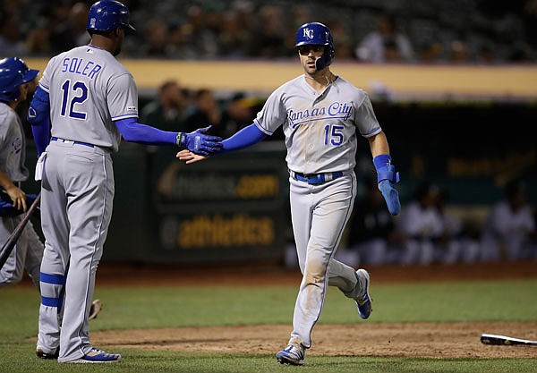 Whit Merrifield of the Royals celebrates with Jorge Soler after scoring the go-ahead run against the Athletics in the ninth inning of Monday night's game in Oakland, Calif.