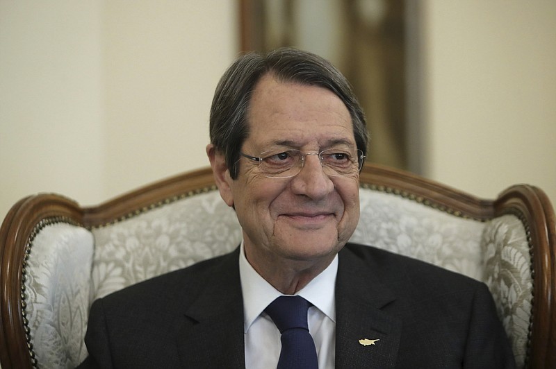 Cyprus' president Nicos Anastasiades smiles during an interview with the Associated Press at the presidential palace in capital Nicosia, Cyprus, Tuesday Sept. 17, 2019. Anastasiades says Turkey's "obsession" to permanently station troops, secure military intervention rights and extend its influence over Turkish Cypriots in any peace deal is fanning fears that it wants to turn the island into a "protectorate." (AP Photo/Petros Karadjias)