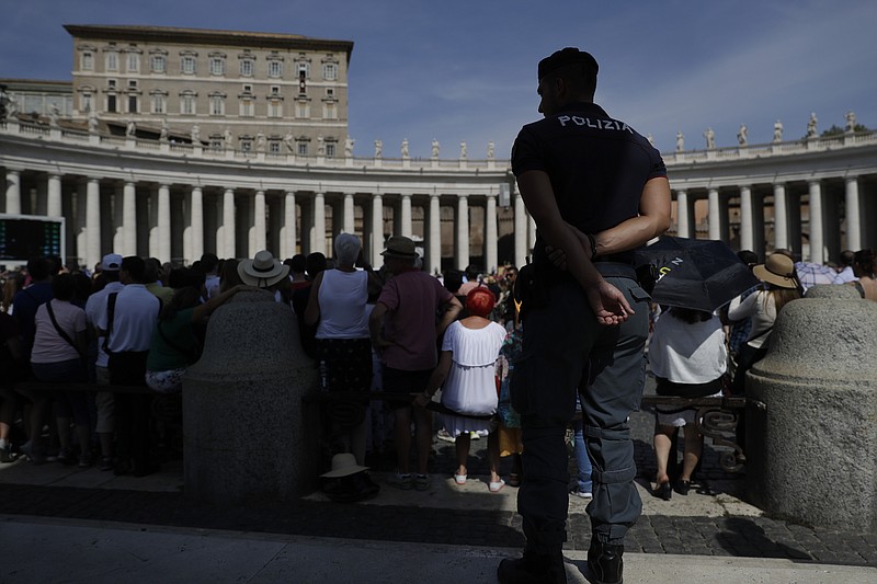 An Italian Police officer watch over faithful as he patrols in St. Peter's Square during Pope Francis' Angelus noon prayer at the Vatican, Sunday, Sept. 15, 2019. (AP Photo/Gregorio Borgia)