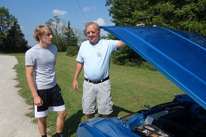 <p>Emily Cole/News Tribune</p><p>Donald Weber, second from right, a founding member of the Mid-Mo Old Car Club, restored this 1970 Dodge Challenger with his grandson, 17-year-old Matt Miller, far left. The car has now been in three generations of the family. Also pictured are Donald’s wife, Becky, far right,and his daughter, Connie</p>