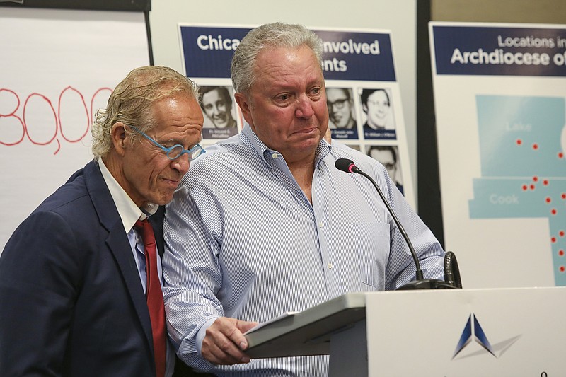 Jeff Anderson, an attorney for victims of sexual abuse by clergy, is joined by abuse victim Joe Iacono as he speaks during a press conference in Chicago, Sept. 17, 2019. Anderson says the Roman Catholic Archdiocese of Chicago has paid $80 million in settlements to clients represented by his law firm alone since 2000. Anderson told reporters in Chicago Tuesday, Sept. 17, 2019 it's the first time he's publicly revealed a total sum of payments to 160 survivors by nearly 50 abusers over 20 years. The Minnesota-based lawyer says the payments averaged $500,000 per victim, with some payouts running into the millions of dollars.  (AP Photo/Teresa Crawford)
