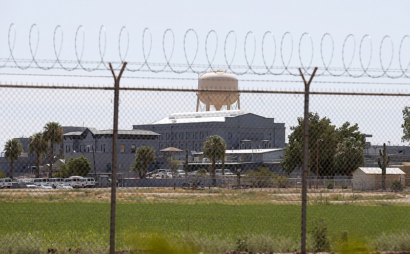 FILE - In this July 23, 2014 file photo, a fence surrounds the state prison in Florence, Ariz., where the execution of Joseph Rudolph Wood took place. A federal appeals court says media should be able to hear and not just see the entire process of executing condemned inmates in Arizona. But the 9th U.S. Circuit Court of Appeals ruled Tuesday, Sept. 17, 2019, that the media and death-row inmates are not entitled to information about the origins of execution drugs or the qualifications of executioners. The case challenges procedures created after the 2014 execution of Joseph Wood, which his attorney said was "horrifically botched." (AP Photo/File)