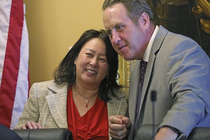 In this Monday, Sept. 16, 2019, photo, Rep. Karen Kwan and Rep. Jefferson Moss speak during a committee hearing at the Utah State Capitol, in Salt Lake City. Utah is the latest of nearly two dozen states across the country that are spending millions of their own money to make sure residents fill out next year's census form amid fears that undercounting could mean losing federal funding or crucial seats in Congress. (AP Photo/Rick Bowmer)