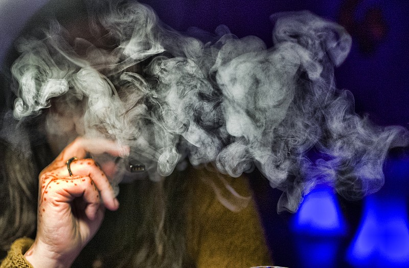 FILE - In this Saturday, Dec. 22, 2018, file photo, a guest takes a puff of a cannabis vape pen during a marijuana event in downtown Los Angeles. (AP Photo/Richard Vogel, File)