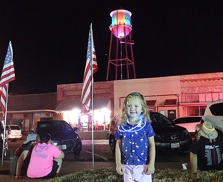 Landry Lemmon, 2, the son of James and Kristy Lemmon of Linden, Texas, attends the celebration of the lighting of Linden, Texas' historic 1934 water tower. The $32,000 project was privately funded and was led by the Linden Heritage Foundation. Staff photo by Neil Abeles