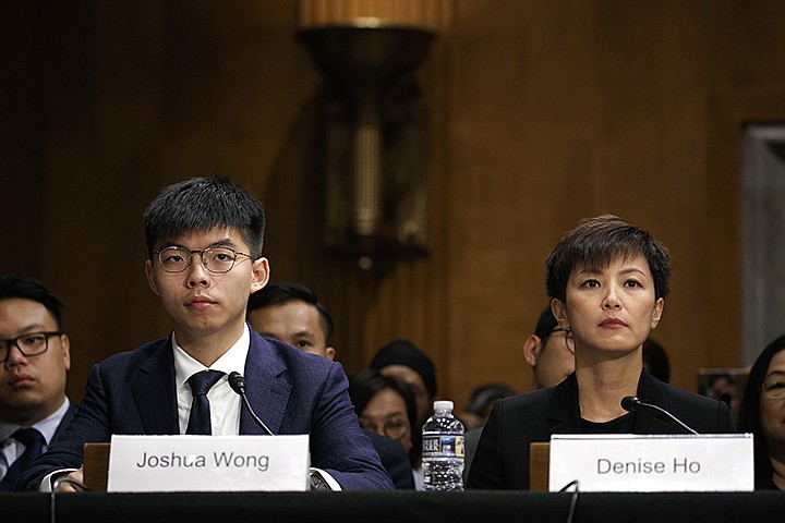 Hong Kong activists Joshua Wong, left, and Denise Ho, attend a congressional hearing about the protests in Hong Kong, Tuesday, Sept. 17, 2019, on Capitol Hill in Washington. (AP Photo/Jacquelyn Martin)
