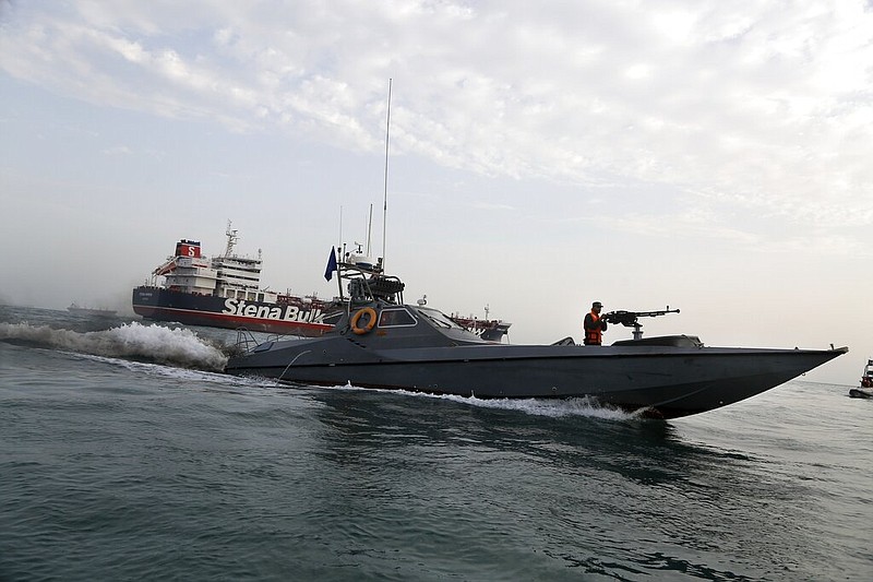 In this July 21, 2019 file photo, a speedboat of the Iran's Revolutionary Guard moves around a British-flagged oil tanker Stena Impero, which was seized on Friday by the Guard, in the Iranian port of Bandar Abbas. The assault on the beating heart of Saudi Arabia's vast oil empire follows a new and dangerous pattern that's emerged across the Persian Gulf this summer of precise attacks that leave few obvious clues of who launched them. (Hasan Shirvani/Mizan News Agency via AP, File)