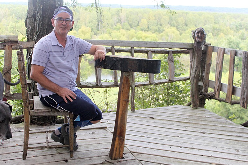 Kevin DeChant sits peacefully on his handmade deck that overlooks the Missouri River at his Sandy Hook home.