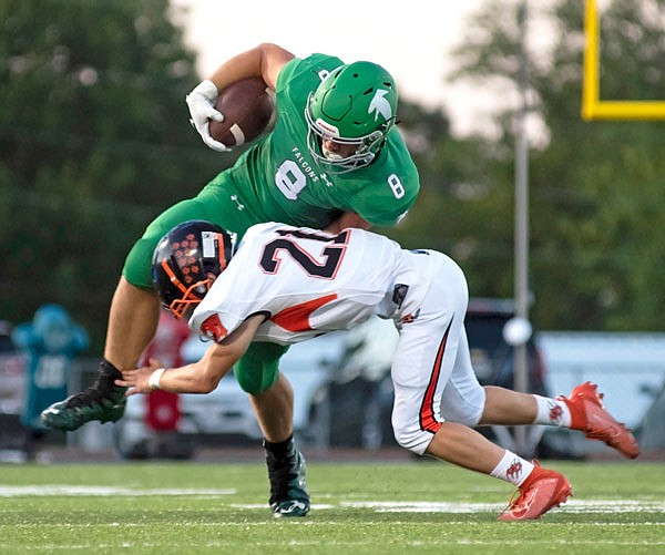 Blair Oaks wide receiver Reid Dudenhoeffer tries to bounce out of an open field tackle by Oak Grove linebacker Richard Lopez after making a catch during a game earlier this month at the Falcon Athletic Complex in Wardsville.