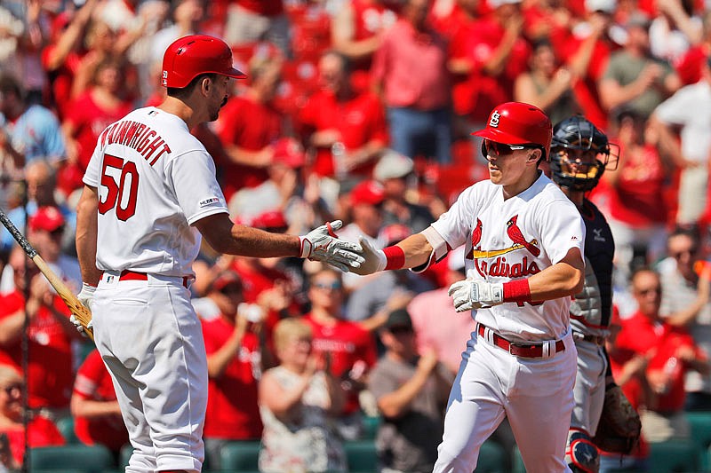 Tommy Edman (right) is congratulated by Cardinals teammate Adam Wainwright after hitting a solo home run during the third inning of Wednesday afternoon's game against the Nationals at Busch Stadium.