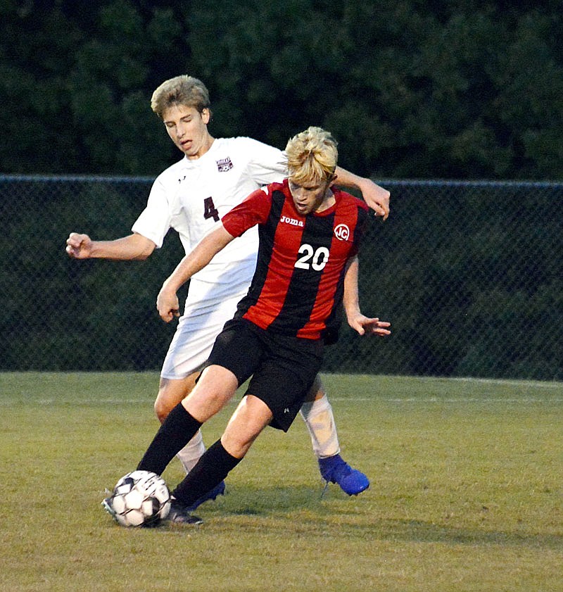 Breck McGrail of Jefferson City dribbles the ball past Joel Schott of Rolla during Wednesday night's game at the 179 Soccer Park.