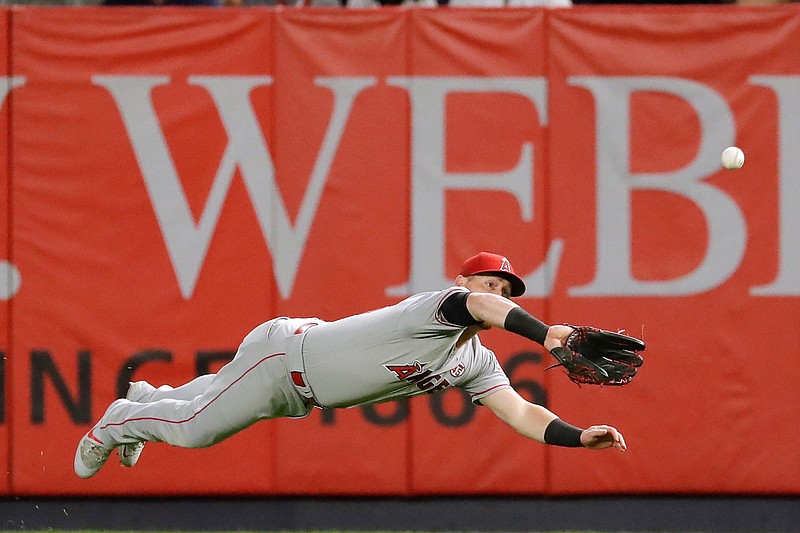 Los Angeles Angels right fielder Kole Calhoun dives to catch a ball hit by New York Yankees' Luke Voit for the out during the second inning of a baseball game Wednesday, Sept. 18, 2019, in New York. (AP Photo/Frank Franklin II)